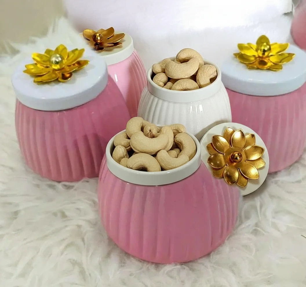 metal jar with golden floral lid handle close up design
